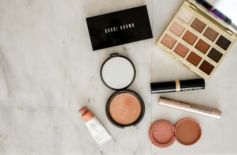 Teen wearing elegant prom makeup with soft smoky eyes and glossy lips, posing confidently
